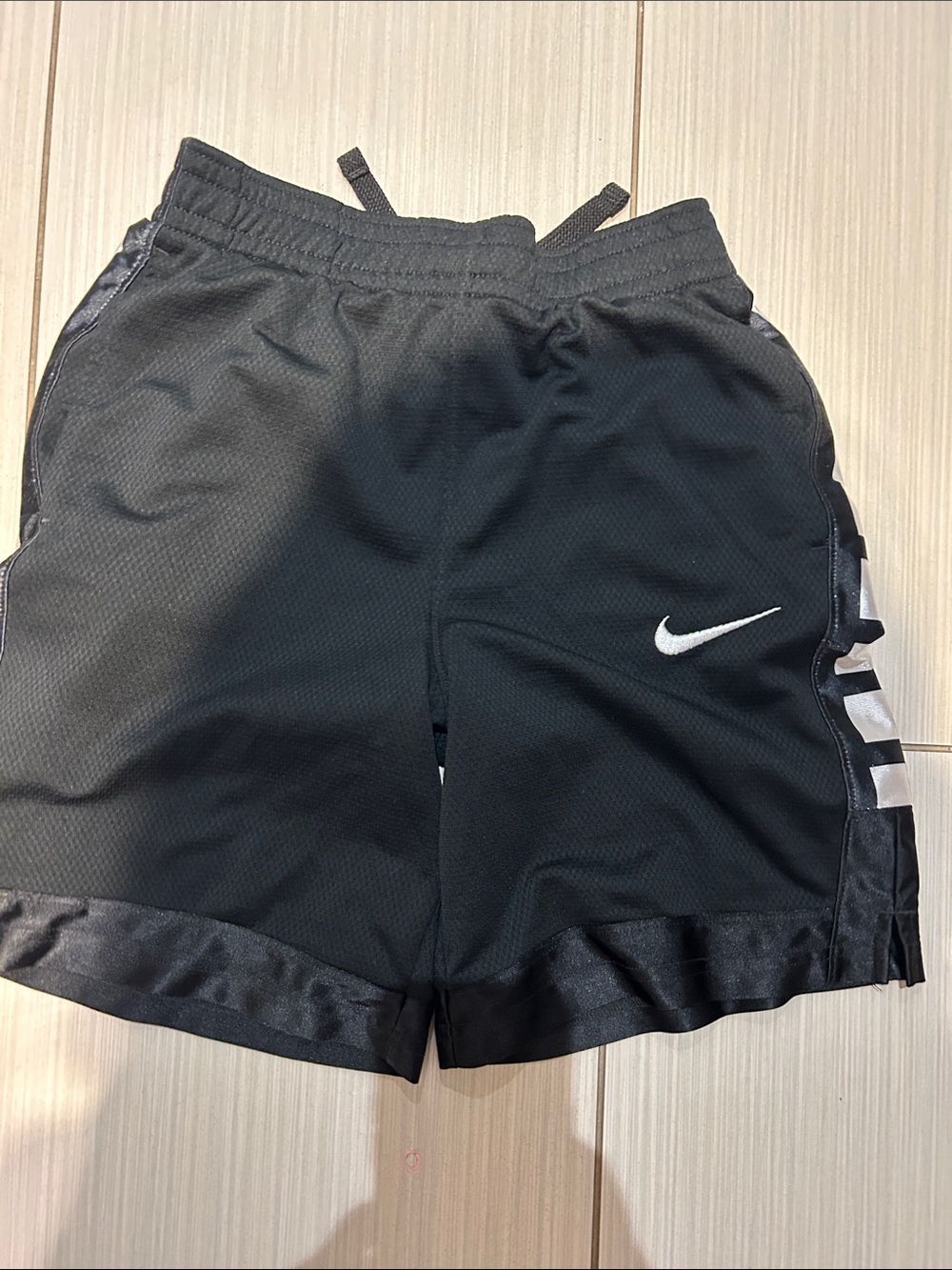 Nike Black Shorts with White Swoosh and Side Stripes
